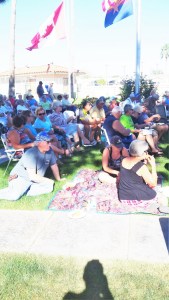 Tim, Jackie, and Pat listening to the music on the grass. We are all young enough we don't need chairs as we can still get up from a sitting position
