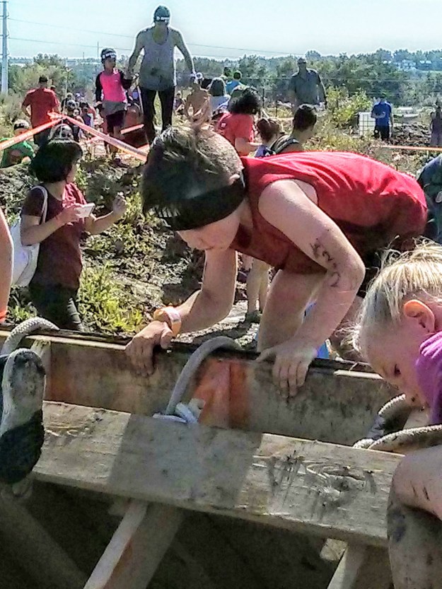 Jackson climbing the wall in the Spartan race