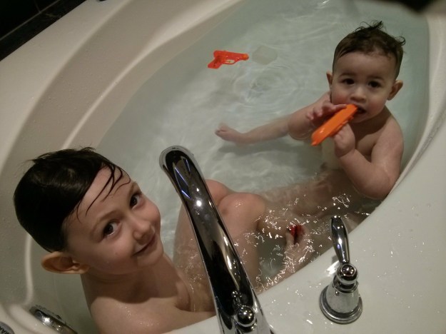 Two boys in a tub rub a tub