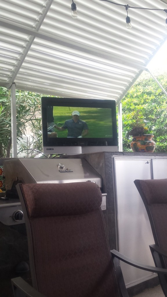 Watching golf on the patio.